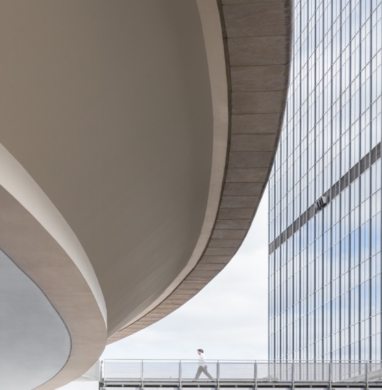 A man walks between Rathbones and Investec Wealth & Investment buildings in the city