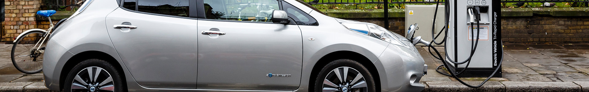 electric car charging on a road