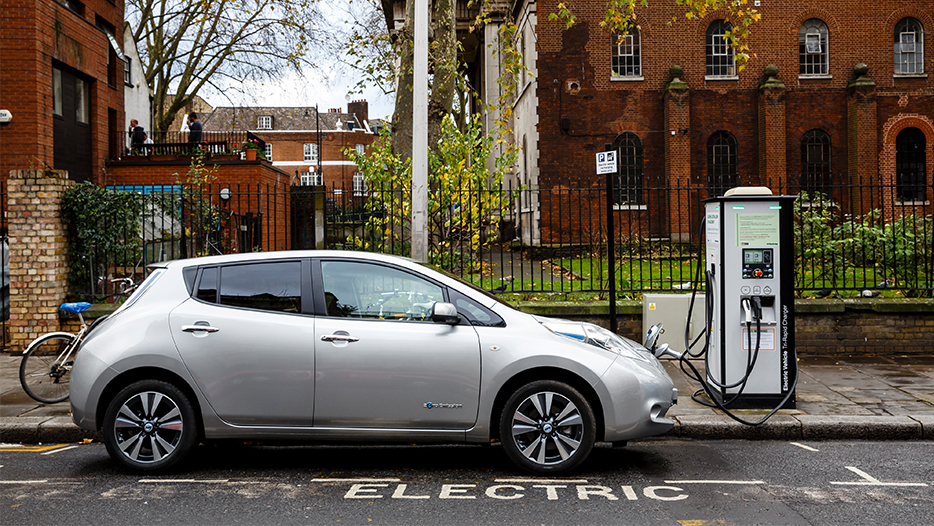 electric car charging on a road